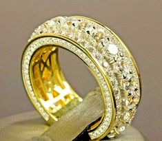 two gold rings with diamonds on top of each other