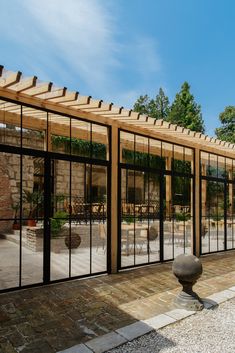 an outdoor patio with glass walls and stone walkway