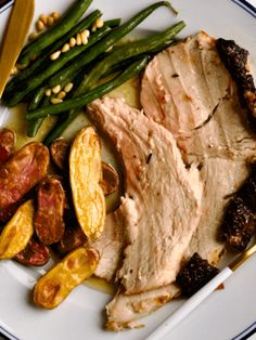 a white plate topped with meat and veggies