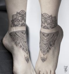 a woman's foot with a tattoo on the top and bottom of her leg