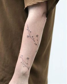 a person with a flower tattoo on their arm