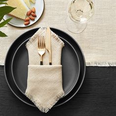 a black plate topped with a fork and knife