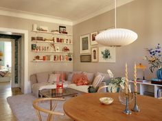 a living room filled with furniture and lots of bookshelves on top of it