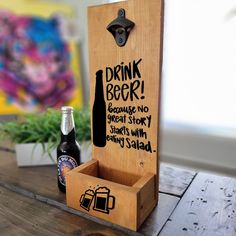 a wooden box with a bottle opener and two bottles in it sitting on a table