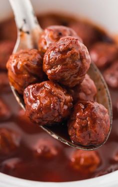 a spoon full of meatballs with sauce