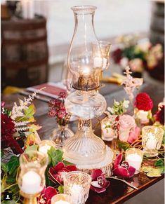 a table with candles and flowers on it