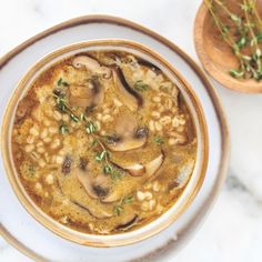 a bowl of soup with mushrooms and beans