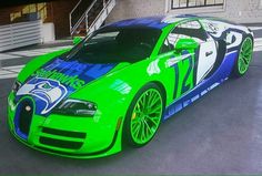 a green sports car painted with blue and white graphics