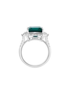 an emerald and diamond ring on a white background