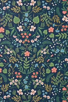 a blue floral wallpaper with pink, green and blue flowers on the left side