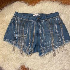 New With Tags, Size L, Stretchy Material But Does Run Slightly Small. Would Fit A 4-6 Best. Diamond Strands Are Sewn Into The Denim And Sway When You Walk. Note The Shorts Are “Distressed” And Have A Rip In The Front And Back Of The Shorts (See Pictures). Would Be Perfect For Your Next Concert Or Festival. See Other Listing For Diamond Dripped Skirt. Summer Party Jean Shorts With Rhinestone Fringe, Summer Party Cutoff Bottoms, Blue Denim Shorts For Party, Party Denim Shorts In Blue, Silver Shorts For Summer Party, Blue Denim Party Shorts, Casual Silver Denim Bottoms, Glamorous Summer Denim Bottoms, Trendy Cutoff Bottoms For Party