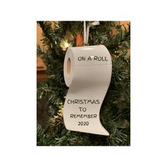 a toilet paper roll ornament hanging from a christmas tree with the words on a roll