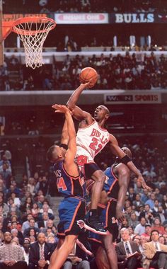 an image of a basketball game going on with the ball in the air and people watching