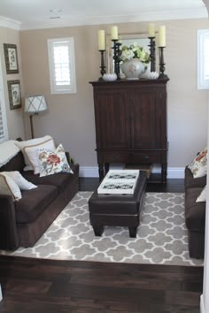 a living room with two couches and a coffee table in front of a dresser