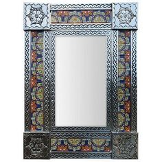 a decorative mirror with an ornate design on the front and back panel, in blue