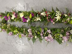 flowers are arranged in the shape of a rectangle with leaves and flowers on each side