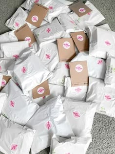 a pile of white bags sitting on top of a carpet covered in pink stickers