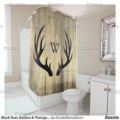 a shower curtain with deer antlers on it in a white and gray color scheme