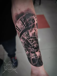 a man's arm with a clock tattoo on it, and the inside of his arm is black and white