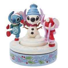 the figurines are all different colors and sizes, including one with a snowman