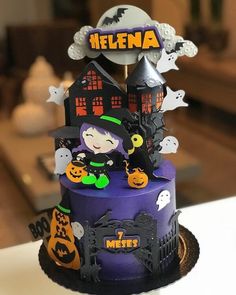 a cake decorated with halloween decorations on top of a table