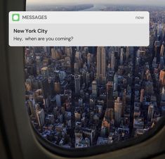 an airplane window showing the view of new york city