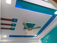 a ceiling fan is mounted to the ceiling in a room with blue and white walls