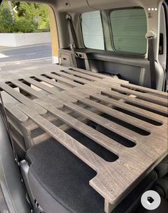 the back end of a van with a wooden slatted bed