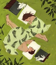 two people laying in the grass next to each other on their stomachs and reading books