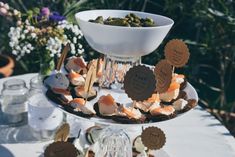 a table topped with plates filled with desserts and cupcakes on top of it