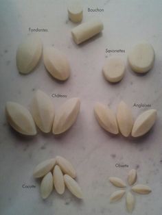 several different types of almonds on a counter top with their names in english and spanish