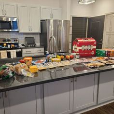 the kitchen counter is covered with food and packaged items