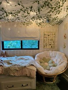 a bed room with a neatly made bed and some lights hanging from the ceiling above it