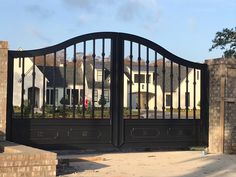 an iron gate is in front of a house