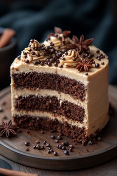 a slice of chocolate cake with white frosting and star anise sprinkles