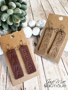 "Genuine Leather \"Mama\" or \"Mama Bear\" Embossed Earrings. Choice of either smooth cocoa brown leather or soft tan leather.  S P E C I F I C A T I O N S - Earrings approximately 2.375\" long and about .625\" wide - Ear wire is antique bronze - Each pair comes with 2 rubber earring backs This listing is for one (1) pair of genuine leather layered earrings. **Please note that color may be slightly different due to monitor displays and pattern may be different due to the nature of the cut on the Leather Earrings Cricut, Mama Earrings, Embossed Earrings, Cricut Earrings, Leather Creations, Layered Earrings, Bear Jewelry, Body Decoration, Mom Earrings