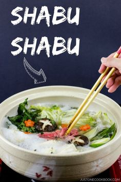 someone holding chopsticks over a bowl of food with the words shabu shabu above it