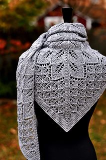 a woman's shawl on top of a black mannequin headdress