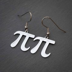 Simple, elegant, and smart...these pi earrings are mathematically proven to be the perfect accessory for every occasion. It features your choice of silver or gold colored steel pi symbols hanging from stainless steel or gold plated ear hooks. Perfect for: Mathematicians or math aficionados Engineers Architects Rational and irrational people alike Anyone cool enough to celebrate Pi Day Pi Decorations, Geometry Earrings, Nerd Earrings, Tetris Earrings, Math Earrings, Pi Symbol, Pi Day, Ear Hook, Teacher Gifts