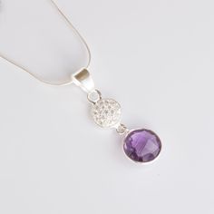 "GENERAL INFORMATION * Materials: 925 Sterling Silver * Gemstone: Amethyst * Style - Minimalist/Birthstone Necklace * Height: 32mm * Width: 10mm * Stone: 10mm Round Gemstone & 1mm Round Cubic Zirconia Accent Stones * Quantity: 1 piece ABOUT THE GEMSTONE Amethyst \"The Stone of Peace\" * Birthstone for February * Zodiac Sign: Aquarius * Significance: Amethyst is known as the \"stone of peace\" and is believed to promote calming energy and clarity of mind. This beautiful gemstone is said to represent strength, courage, and wisdom, making it the perfect addition to any woman's jewelry collection. Whether you're looking to add a pop of colour to you ABOUT THE PRODUCT This necklace features a 10mm Round Gemstone accented by 1mm sparkling White Cubic Zirconia stones. The simple and elegant desig Sterling Silver Pendant With Gemstone Accents, Sterling Silver Pendant Crystal Necklace With Stones, Purple Sterling Silver Necklace With Gemstone Accents, Purple Gemstone Necklace In Cubic Zirconia, Purple Gemstone Necklace With Cubic Zirconia, Purple Cubic Zirconia Gemstone Necklace, Silver Birthstone Pendant Necklace, Sterling Silver Necklace With Stone Setting In Round Pendant, Purple Necklace With Sparkling Stones For Gift