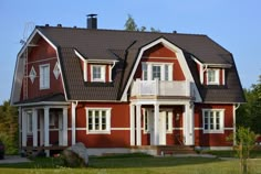 a red house with white trim and windows