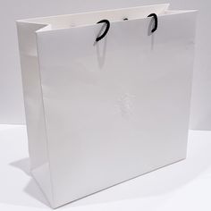 Authentic Chanel Empty Small Paper Shopping Bag, Used. With Branded Ribbon Color: White Material: Paper And Cardboard Nameplate: Chanel Iconic Logo Dimensions: 12.25” X 12” X 5” Ribbon Length: 64” Large White Luxury Bag, Elegant Large White Bag, Large White Bag With Top Carry Handle, Modern White Bag For Gift, Formal White Box Bag With Dust Bag, Classic White Box Bag For Shopping, White Classic Box Bag For Shopping, Modern White Box Bag For Gift, Branded Ribbon