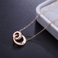 A unique pendant sits at the center of this elegant necklace that boasts a luxurious 18k rose gold-plated design for added shimmer. Chain: 15.75'' L with 2'' extender Pendant: 0.59'' W x 0.35'' L Lobster claw clasp 18k rose gold-plated steel / cubic zirconia Rose Gold Stainless Steel Pendant Jewelry, Rose Gold Stainless Steel Pendant, Rose Gold Plated Round Necklace, Rose Gold Cubic Zirconia Round Necklace, Rose Gold Cubic Zirconia Necklace, Rose Gold Plated Round Jewelry, Formal Rose Gold Stainless Steel Necklace, Rose Gold Stainless Steel Jewelry For Anniversary, Rose Gold Jewelry With Adjustable Chain In Stainless Steel