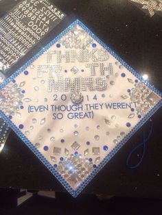 a white and blue graduation cap with the words thank you, even though they weren't so great