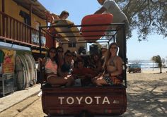 a group of people riding in the back of a truck