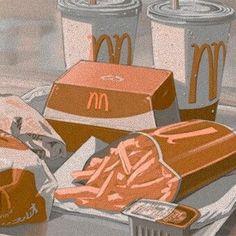 mcdonald's fries, hotdogs and drinks are sitting on the table next to each other