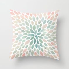 a pillow with an abstract flower design on the front and back cover in pastel colors