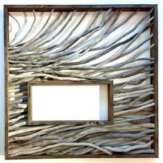 a wooden frame made out of driftwood with a white blank space in the middle