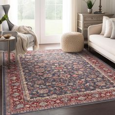 a living room filled with furniture and a large rug