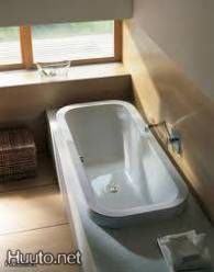 a bath tub sitting next to a window in a bathroom